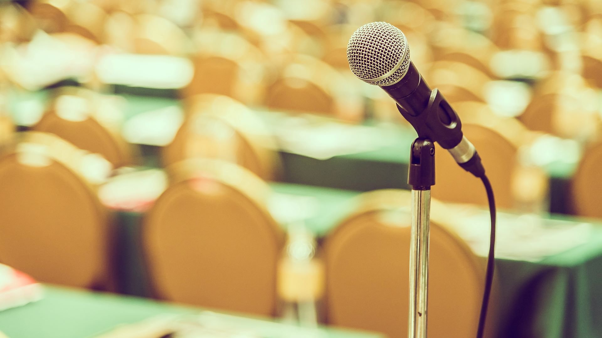 Microphone and conference room at Cruise Planners franchise convention