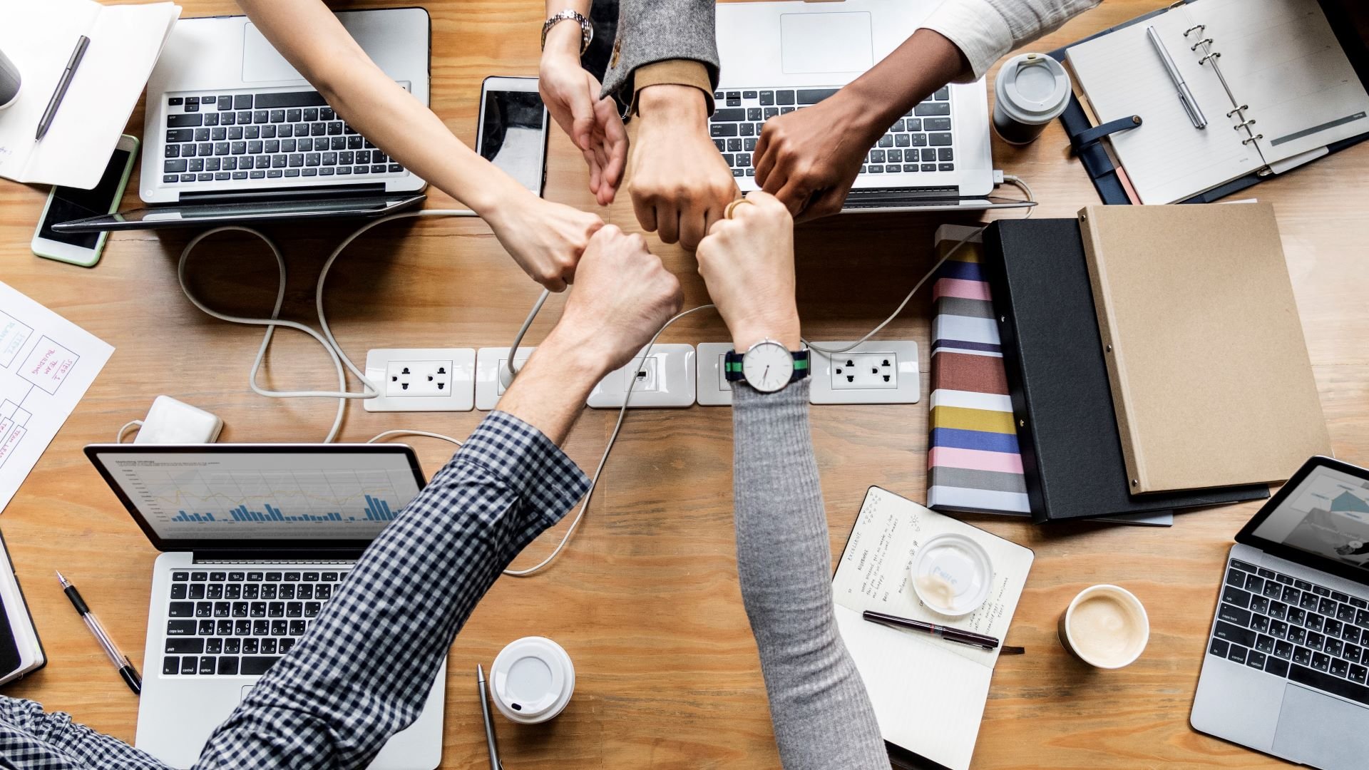 Video marketing team collaborating and fist-bumping