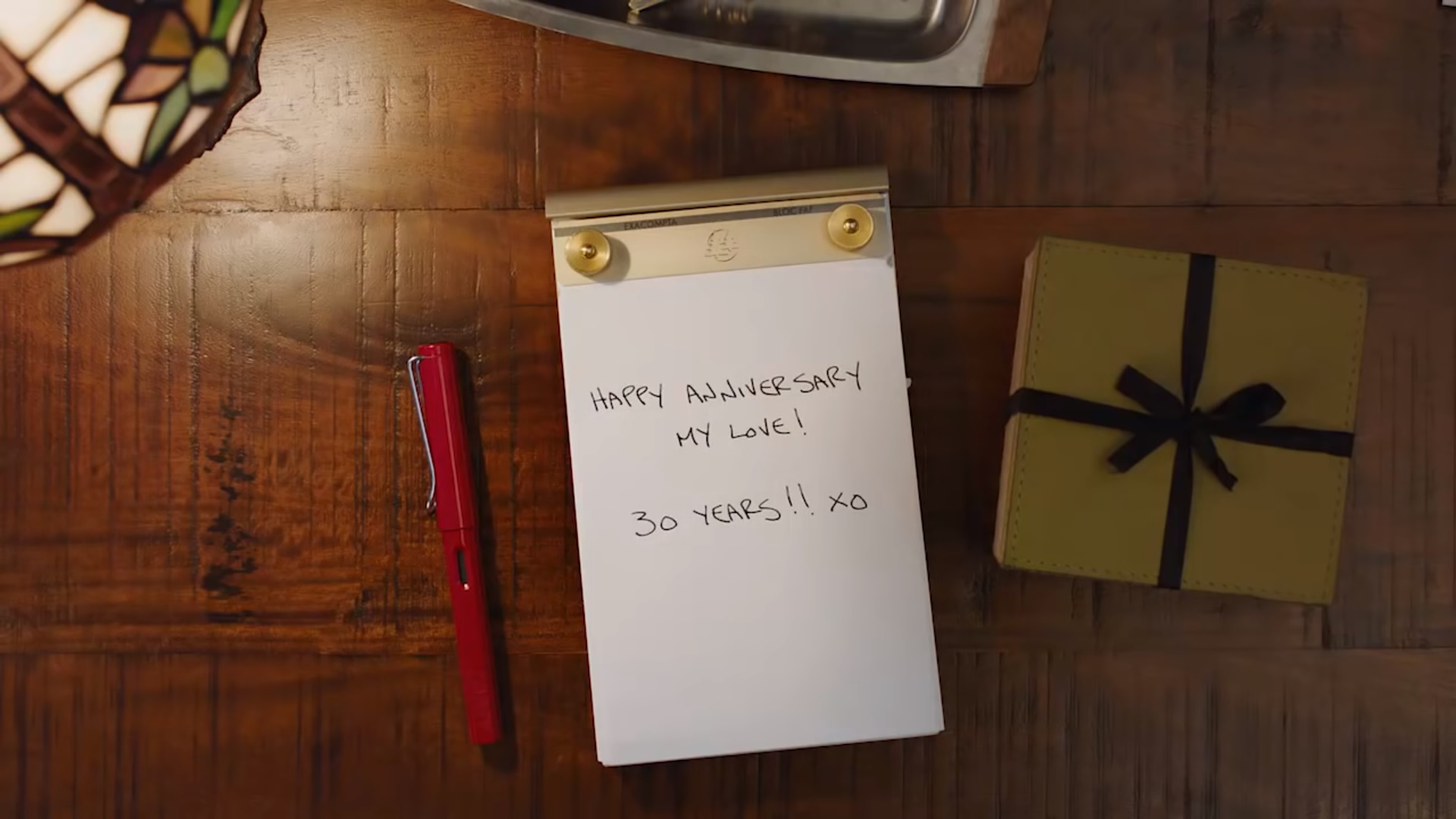 Notepad with 'happy anniversary' message from branded company video