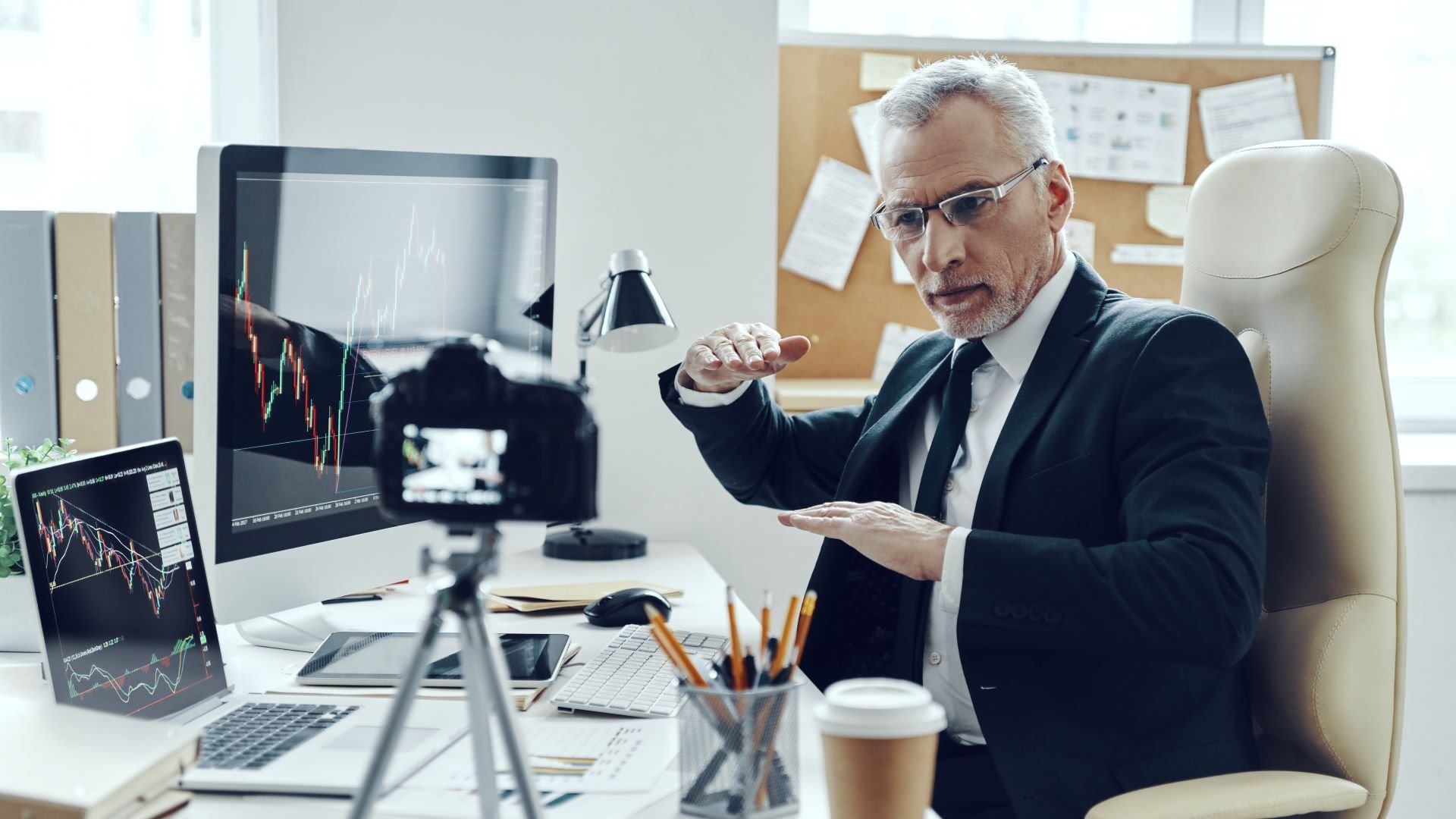 Businessman filming a killer corporate video in his office