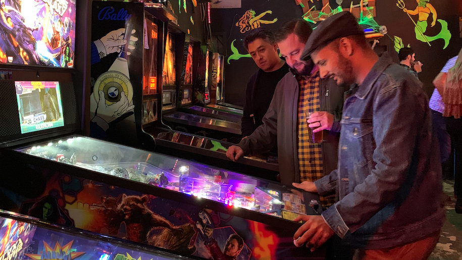 Marketing agency partners strategizing new vision over a pinball machine